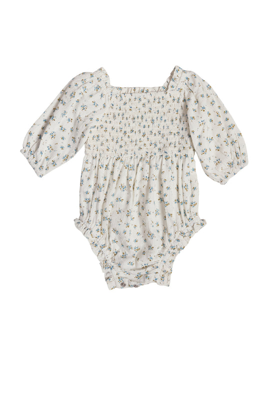 The Ivy City Co Baby Madeline Romper in Blue features long sleeves, a smocked design, and a charming floral print on white. With elastic cuffs for comfort, it makes an adorable Easter outfit for your little one.