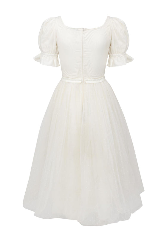 The Ballerina Dress in White by Ivy City Co features vintage charm with short puff sleeves, a fitted bodice, back zipper, and a dotted knee-length skirt—an elegant choice for those seeking classic ballerina style.