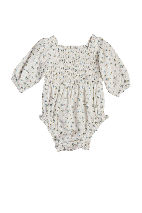 The Baby Madeline Romper in Blue by Ivy City Co features long puffed sleeves, a square neckline, and a shirred bodice. Crafted from white fabric adorned with a delicate blue and green floral print, this charming blue floral romper makes an adorable choice for an Easter outfit.