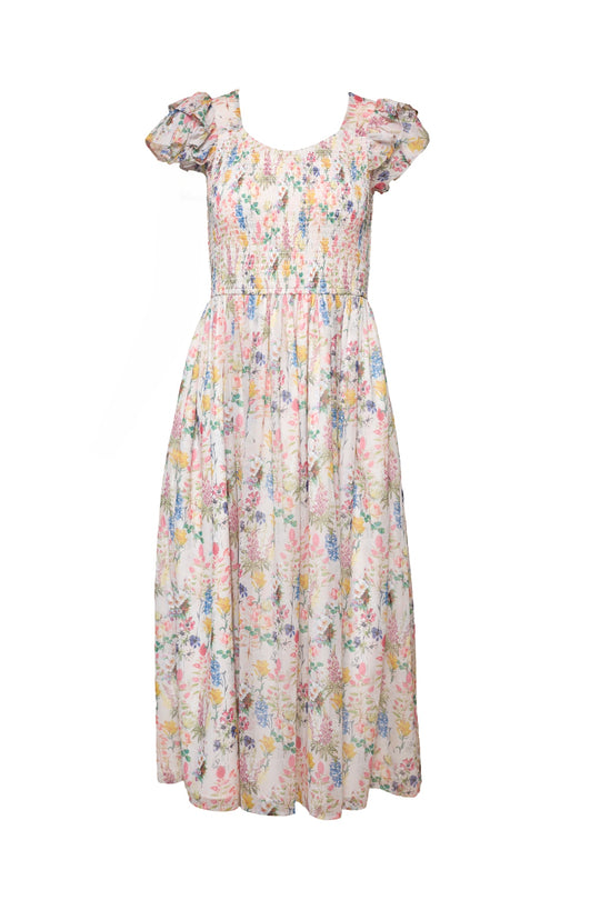 The Hattie Dress in Cordelia Floral by Ivy City Co is a pastel pink, blue, and yellow floral A-line midi with short puff sleeves, a smocked bodice, flowing skirt, and maternity-friendly fit for an effortlessly elegant look.