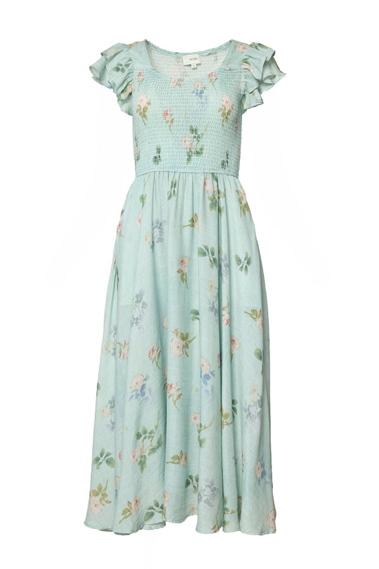 The Hattie Dress in Roselyn Blue by Ivy City Co is a maternity-friendly, ankle-length cotton-linen dress featuring a floral print, short ruffled sleeves, smocked bodice, and flowing skirt for comfort and style.