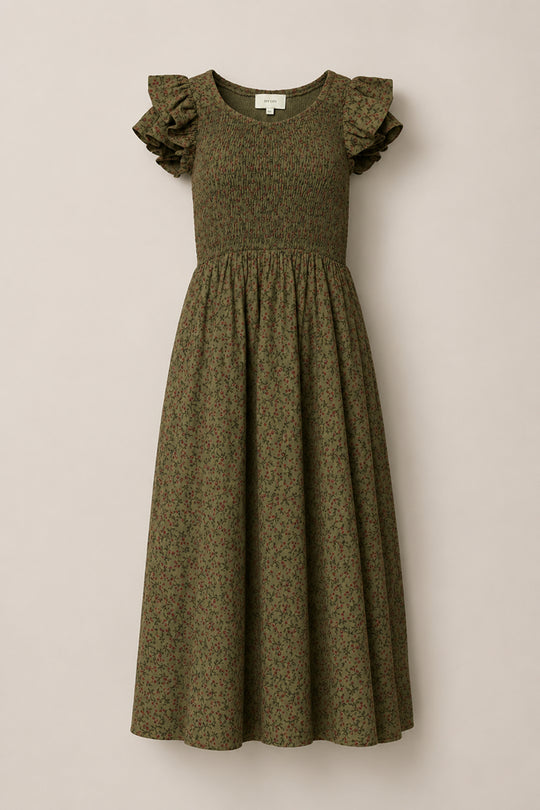 The Hattie Dress in Woodland Floral by Ivy City Co showcases a smocked bodice, ruffled cap sleeves, and a flowy skirt adorned with a subtle floral pattern. Maternity friendly and beautifully designed, this dress is displayed on a light neutral background.
