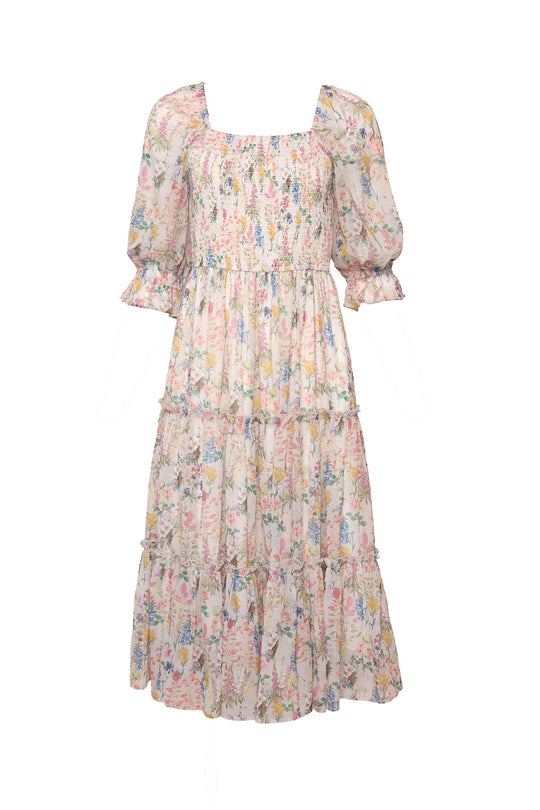 The Ivy City Co Madeline Dress in Cordelia Floral features a light, knee-length silhouette with a square neckline, puffed half sleeves, a tiered skirt, and a white fabric adorned with delicate pastel multicolored floral print.