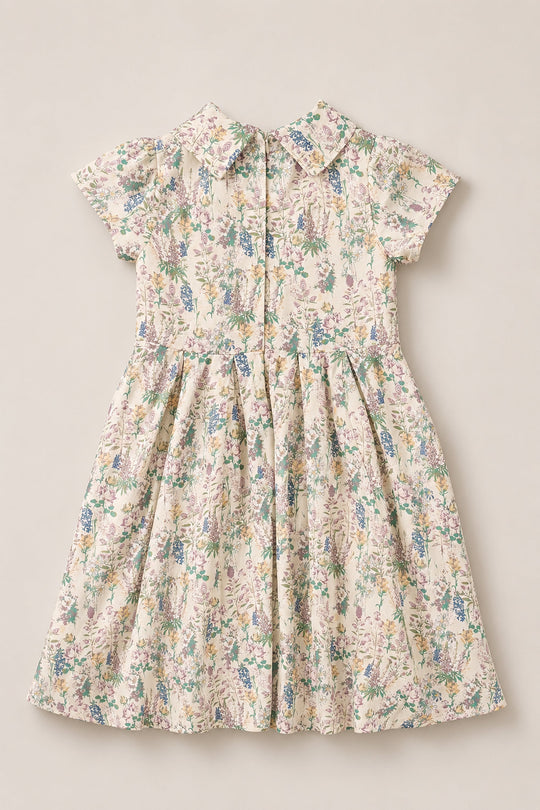 The Mini Amber Dress in Autumn Bouquet by Ivy City Co is a short-sleeve, knee-length dress featuring a collared neckline and a pastel floral pattern. Delicate pleats at the waist pair with button details down the front, making it the perfect collared-neckline dress for any occasion.