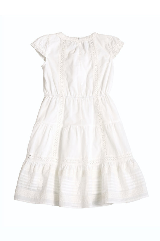 The Ivy City Co Mini Palermo Dress in White, featuring puff sleeves, lace trim, a gathered waist, and a tiered skirt, is displayed flat against a plain white background.