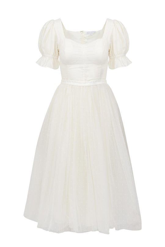 The Ivy City Co Ballerina Dress in White features puffed short sleeves, a fitted bodice, square neckline, and flared skirt with subtle polka dots—ideal for a dreamy ballerina-inspired look.