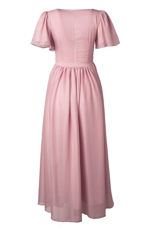 Back view of the Abbie Dress in Blush by Ivy City Co, showcasing short flutter sleeves, a fitted waist, a flowing ankle-length skirt, and a visible back zipper. The lightweight, slightly sheer fabric adds elegance, making it an ideal choice for a modest bridesmaid dress.