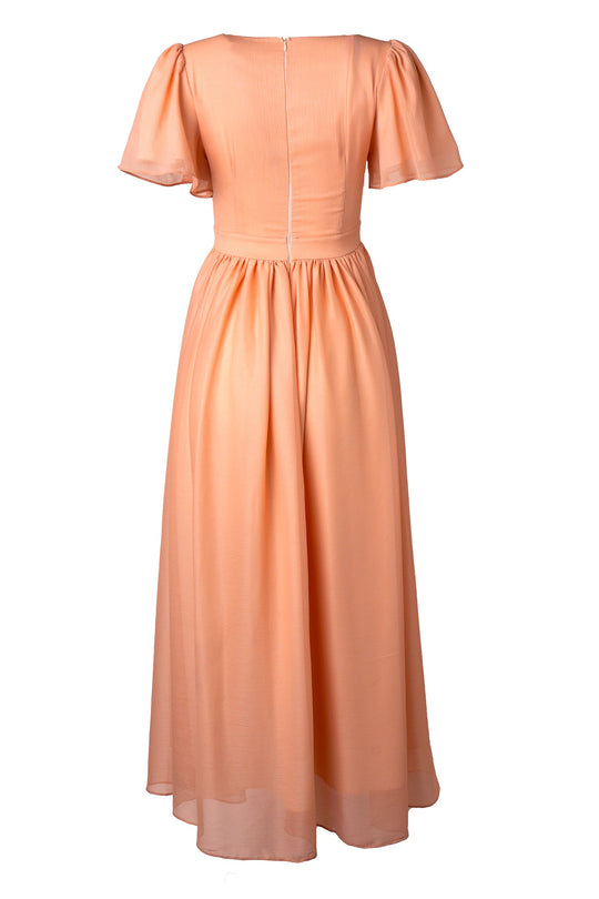 Abbie Dress in Apricot Crush by Ivy City Co: Peach-colored, short-sleeve, ankle-length dress featuring a fitted bodice, flared skirt, and visible back zipper, displayed on a white background. This versatile maxi dress is an elegant choice for bridesmaids or any special occasion.