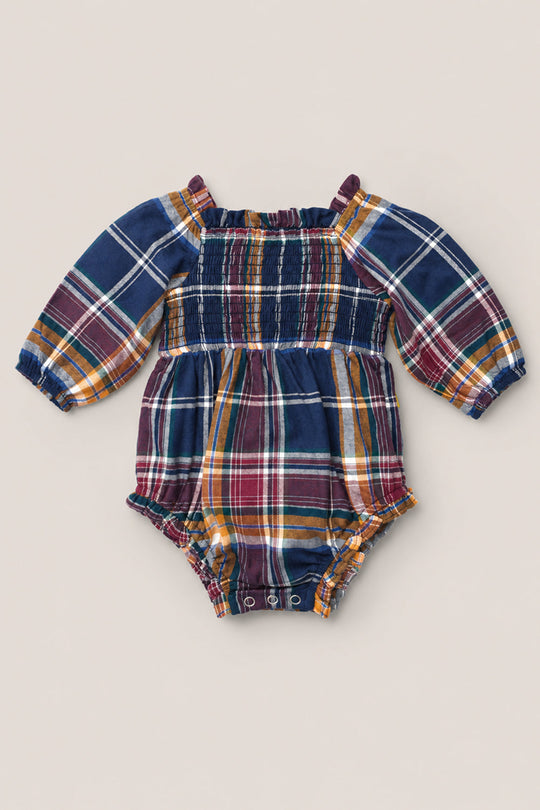 The Baby Madeline Romper in Midnight Plaid by Ivy City Co features a charming plaid design with a smocked bodice, puff sleeves, elastic cuffs, and convenient snap closures at the bottom. Available in navy blue, burgundy, yellow, and white.