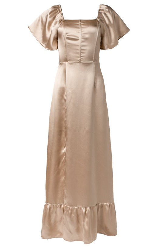 The Maddie Dress in Champagne Satin by Ivy City Co features a long, shiny satin silhouette with short flutter sleeves, a square neckline, a corset-inspired fitted bodice, and a ruffled hem—making it an elegant and modest choice for bridesmaids or special occasions.