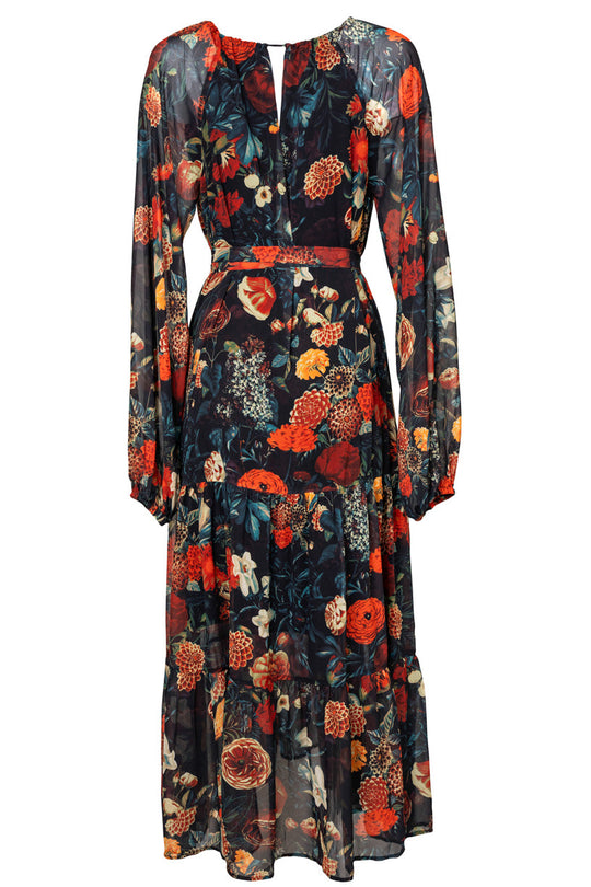 The Imogen Dress in Moody Floral by Ivy City Co is a long-sleeved, ankle-length maxi dress showcasing a dark background with vibrant red, orange, and green floral print. Featuring sheer sleeves, a keyhole neckline, a slightly cinched waist, and a tiered skirt, this maternity friendly style blends elegance and comfort for any occasion.